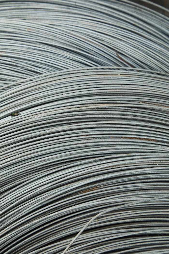 Abstract background of thin fragile white many wires placed chaotically in rows and lines